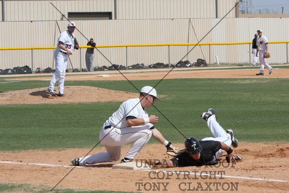 Zach Neal And Miles Hamblin Holding The Base Runner Close To The Bag