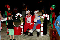 Santa And Mrs. Claus And Elves Listen To A Child