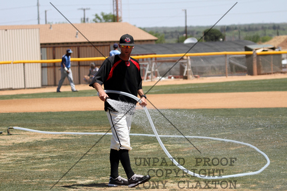 Coach Jake Carlson Watering The Base Paths