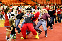 Howie The Hawk And Rodeo Team Members Competing In Limbo