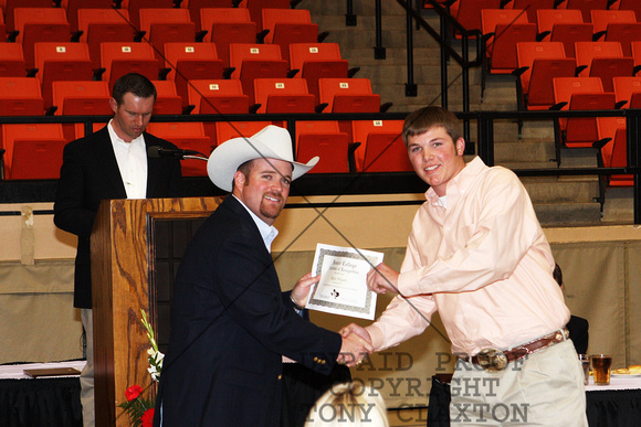 Ross Wyatt Receiving A Livestock Judging Certificate From Cash Berry