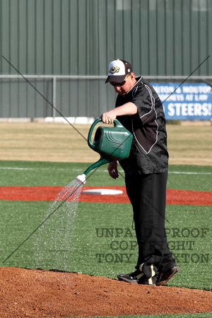 Coach Otto Watering The Pitcher's Mound
