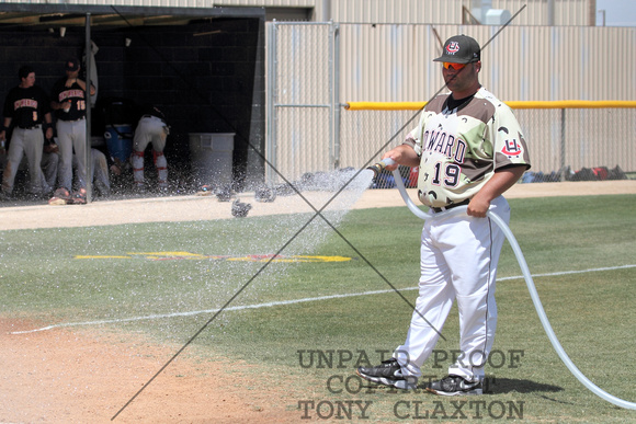 Coach J-Bob Thomas Watering The Infield Between Games