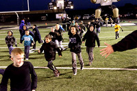 Elementary Students Running Onto The Field