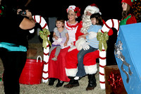 Santa And Mrs. Claus And An Elf Have Their Picture Taken With Two Children