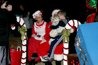 Santa And Mrs. Claus Pose With A Child
