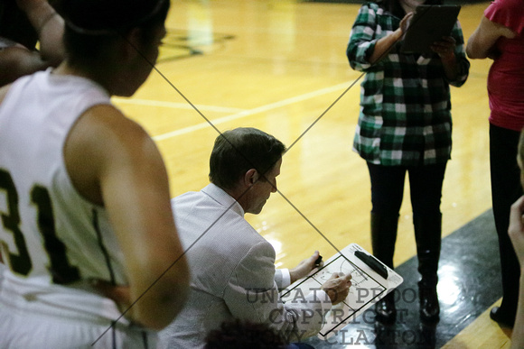 Coach Mike Warren Drawing Up A Play In The Huddle