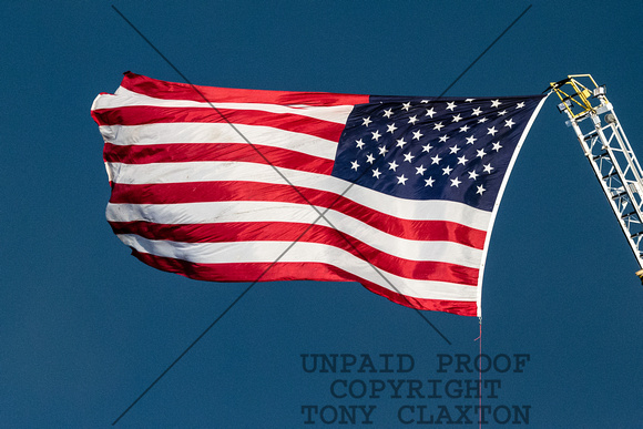 American Flag In Front Of Dark Cloud