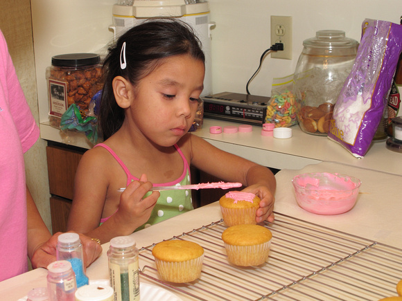 Kaylee Spreading Frosting On A Cupcake