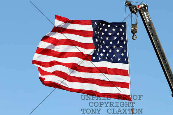 United States Flag Flying From A Crane