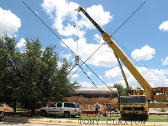 Crane Lifting Tank Out Of The Ground